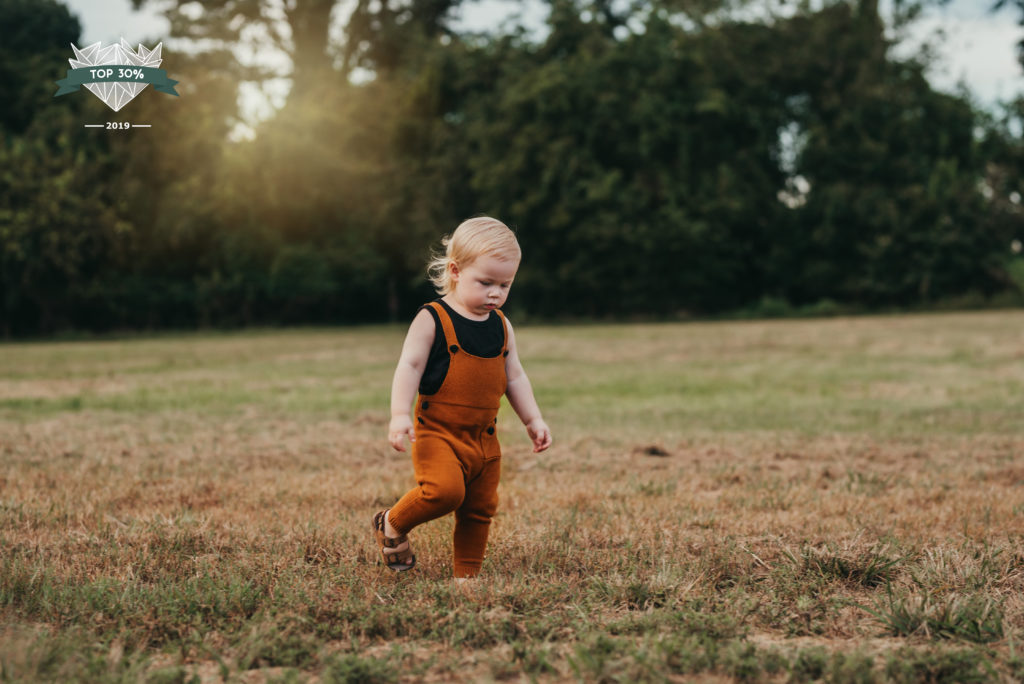 toddler boy in field during photosession in Tampa