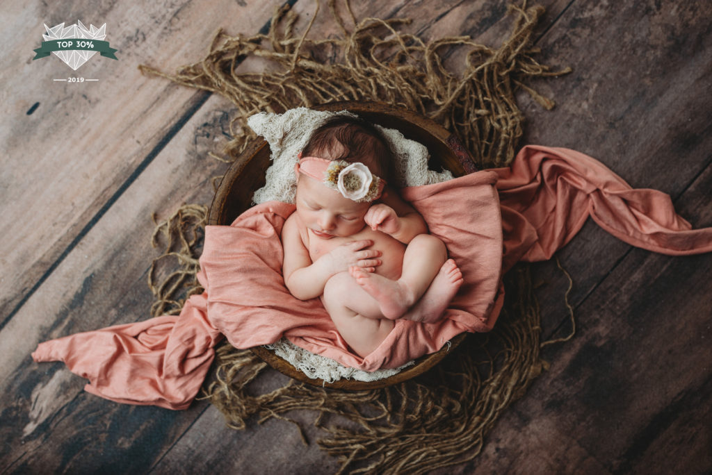 newborn girl in bowl during photography session in Tampa, FL