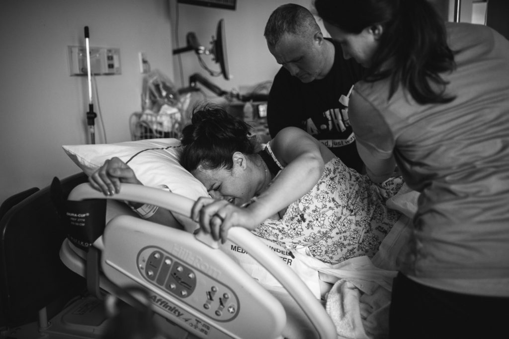 Mom breathing through contraction during birth in Annapolis, MD at AAMC