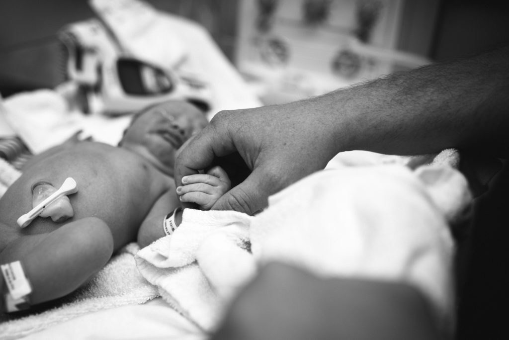 Dad holds baby's hand for first time in Annapolis, MD at AAMC