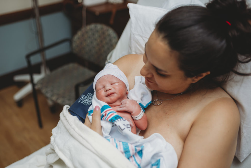 Mom holds new baby after birth in Annapolis, MD at AAMC