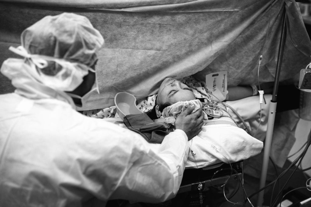 dad supports mom during c-section at hospital in Annapolis, MD