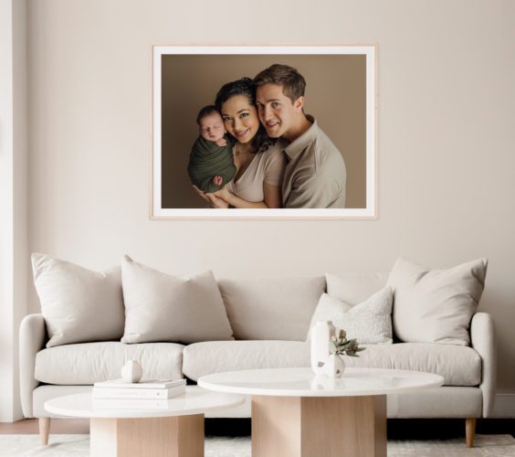 tampa newborn photographer displays large framed matted wall portrait in living room