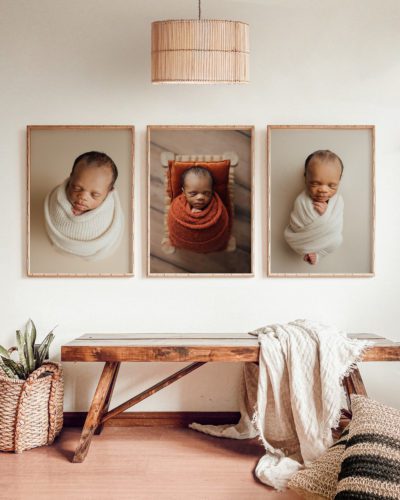 tampa newborn photographer displays framed matted portraits in a wall gallery in home