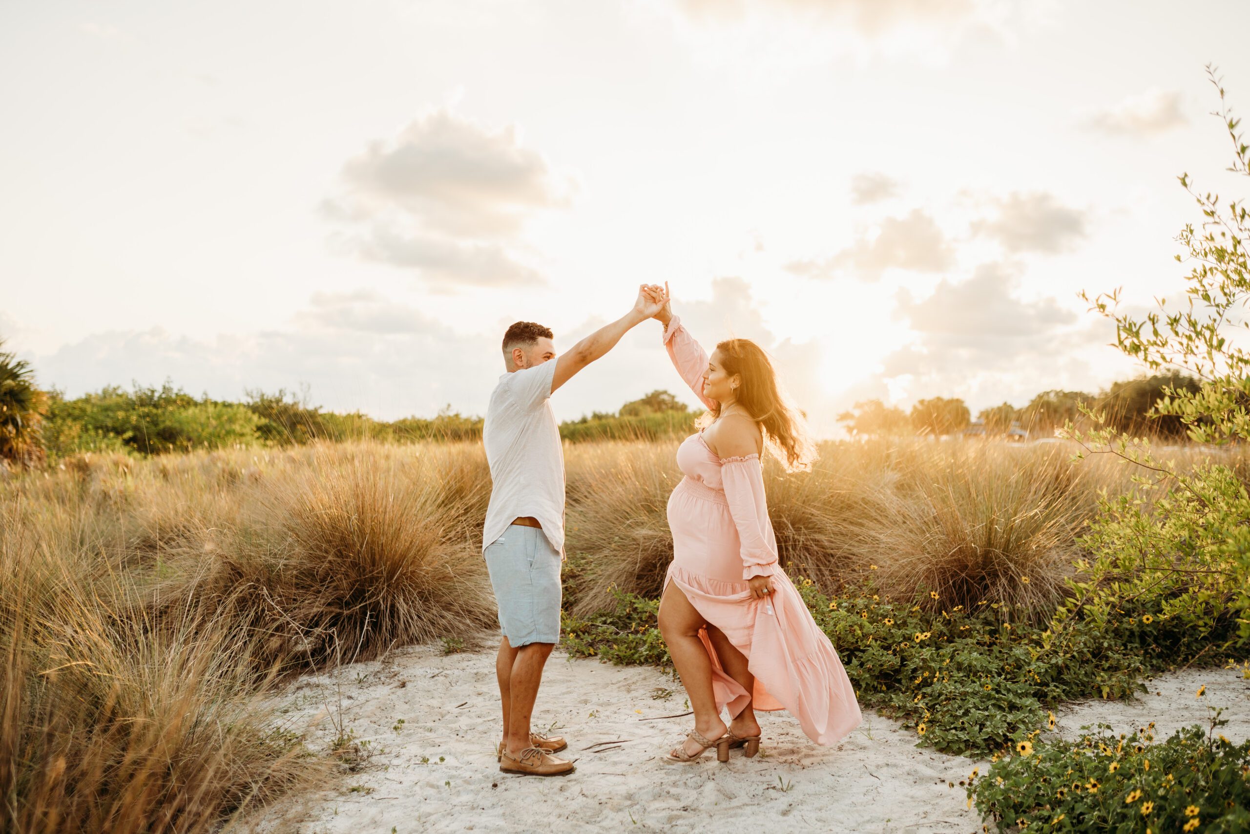 pregnant mom with spouse at field in tampa for maternity portraits