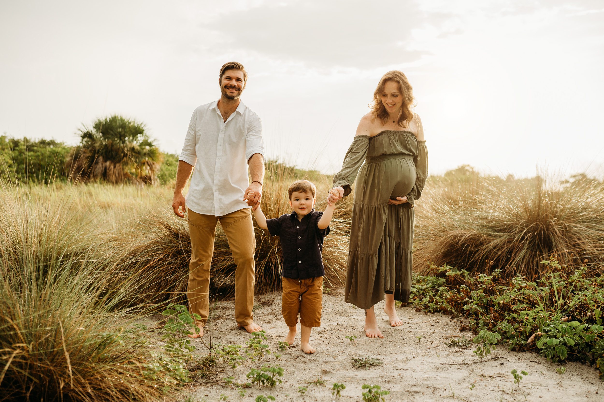 family maternity session at field in Tampa
